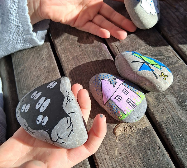 Children with painted storytelling stones